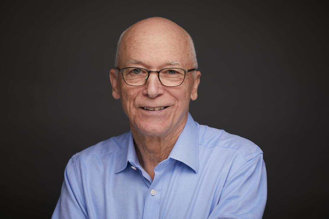 Geoffrey M. Heal, Donald C. Waite III Professor of Social Enterprise at Columbia Business School, against a black background. He is known for his contributions to economic theory and resource and environmental economics.